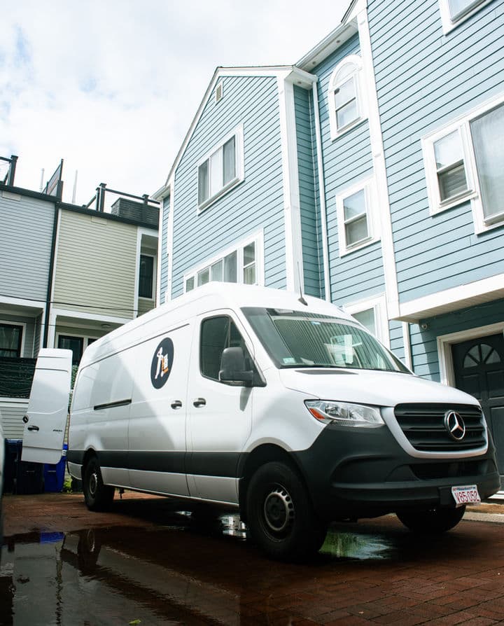 Small Haul Mercedes Sprinter van parked outside a residential building