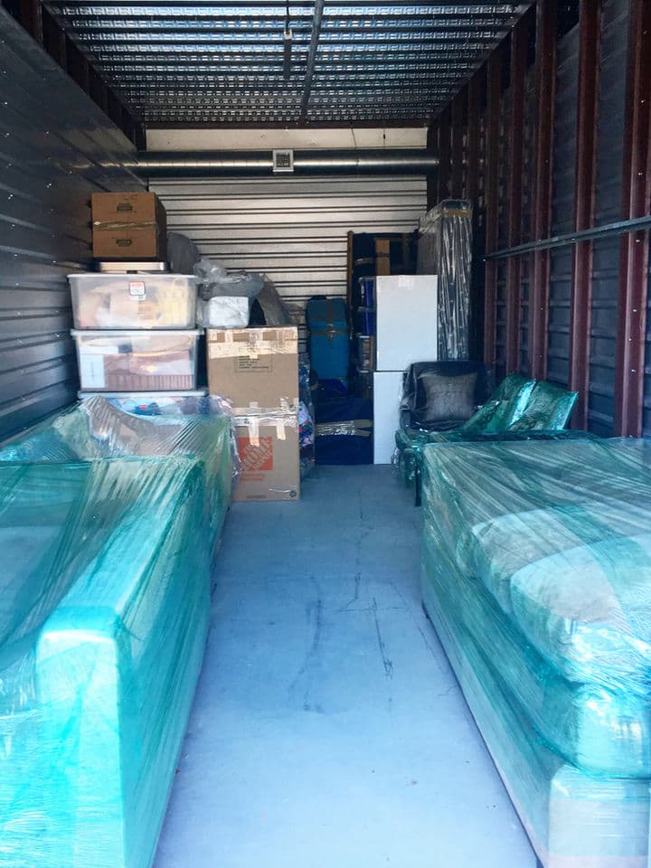 Wrapped furniture and boxes inside a climate-controlled storage facility