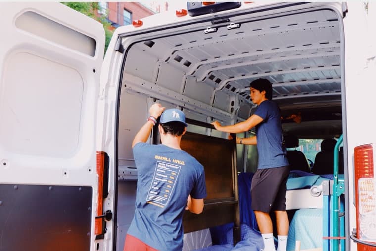 Small Haul movers loading a wardrobe into a van in Fort Collins