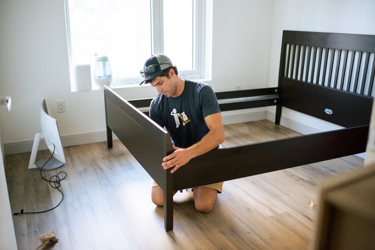A Small Haul mover assembling a bed frame in a Denver apartment