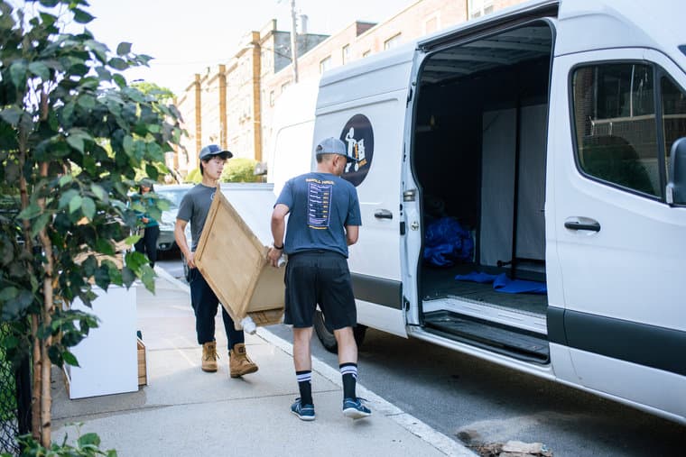 Small Haul movers carrying boxes on a Boulder sidewalk