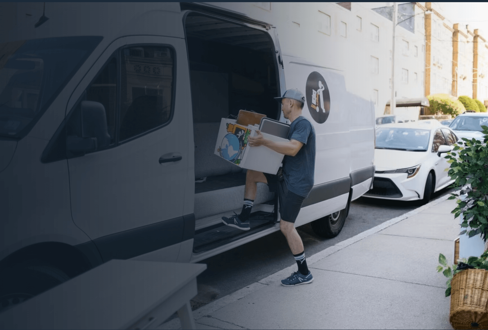 Small Haul hauler loading furniture into a Sprinter van in Denver